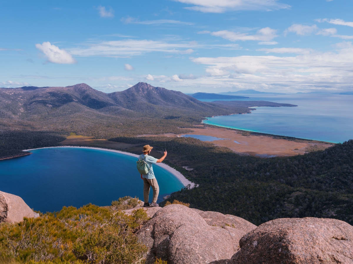 Image of a person using mobile phone in a remote island region