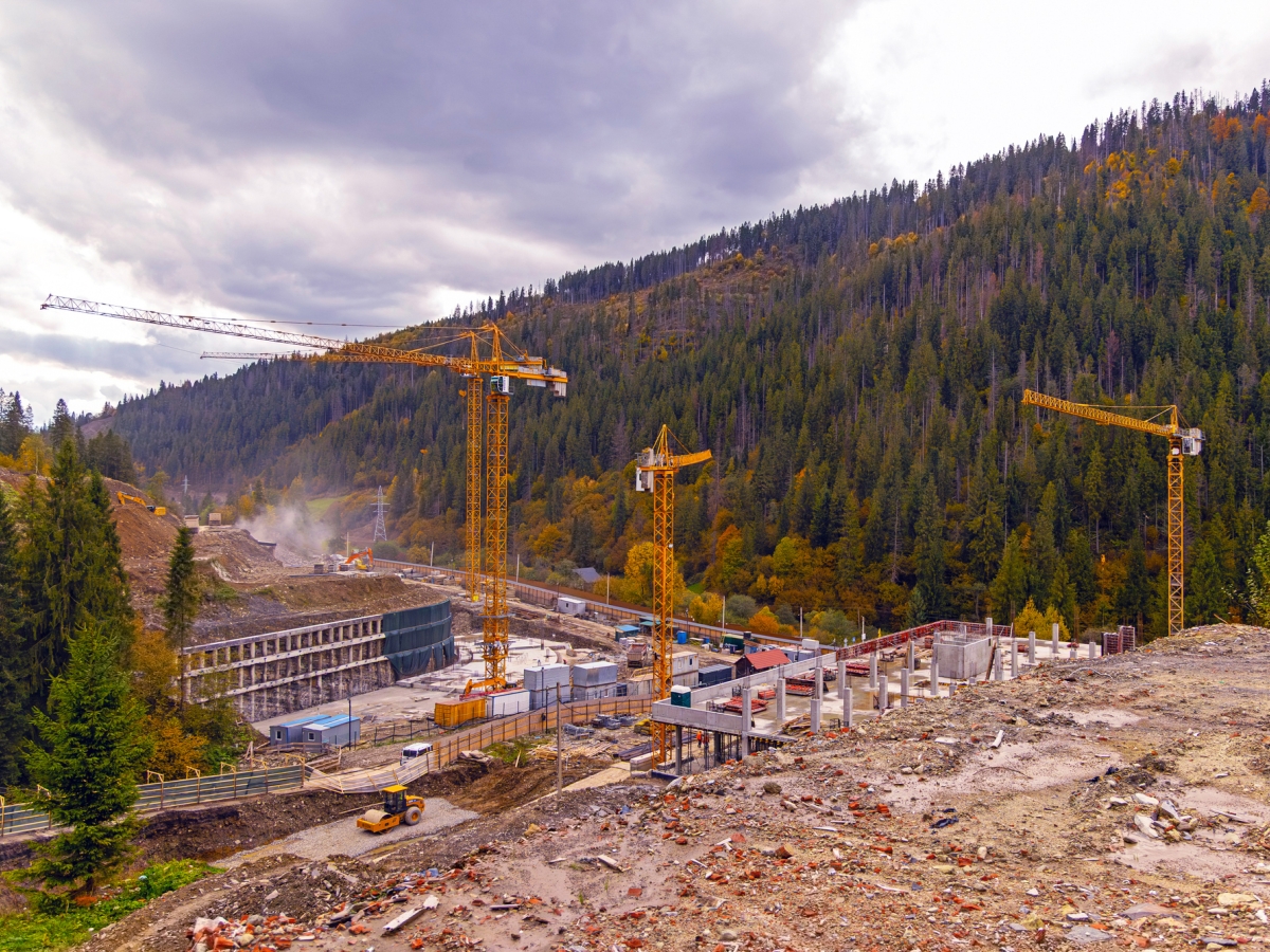A construction site with cranes in a remote location