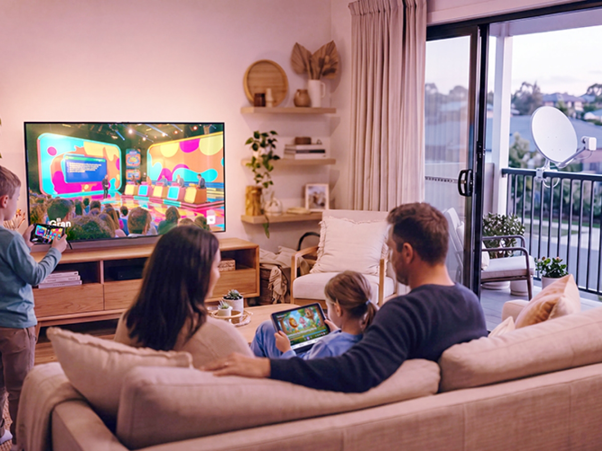 Family sitting on the couch watching television
