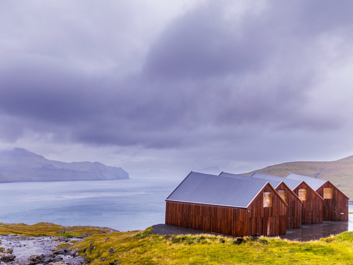Image of warehouses in a remote region overlooking a mountainous coastline