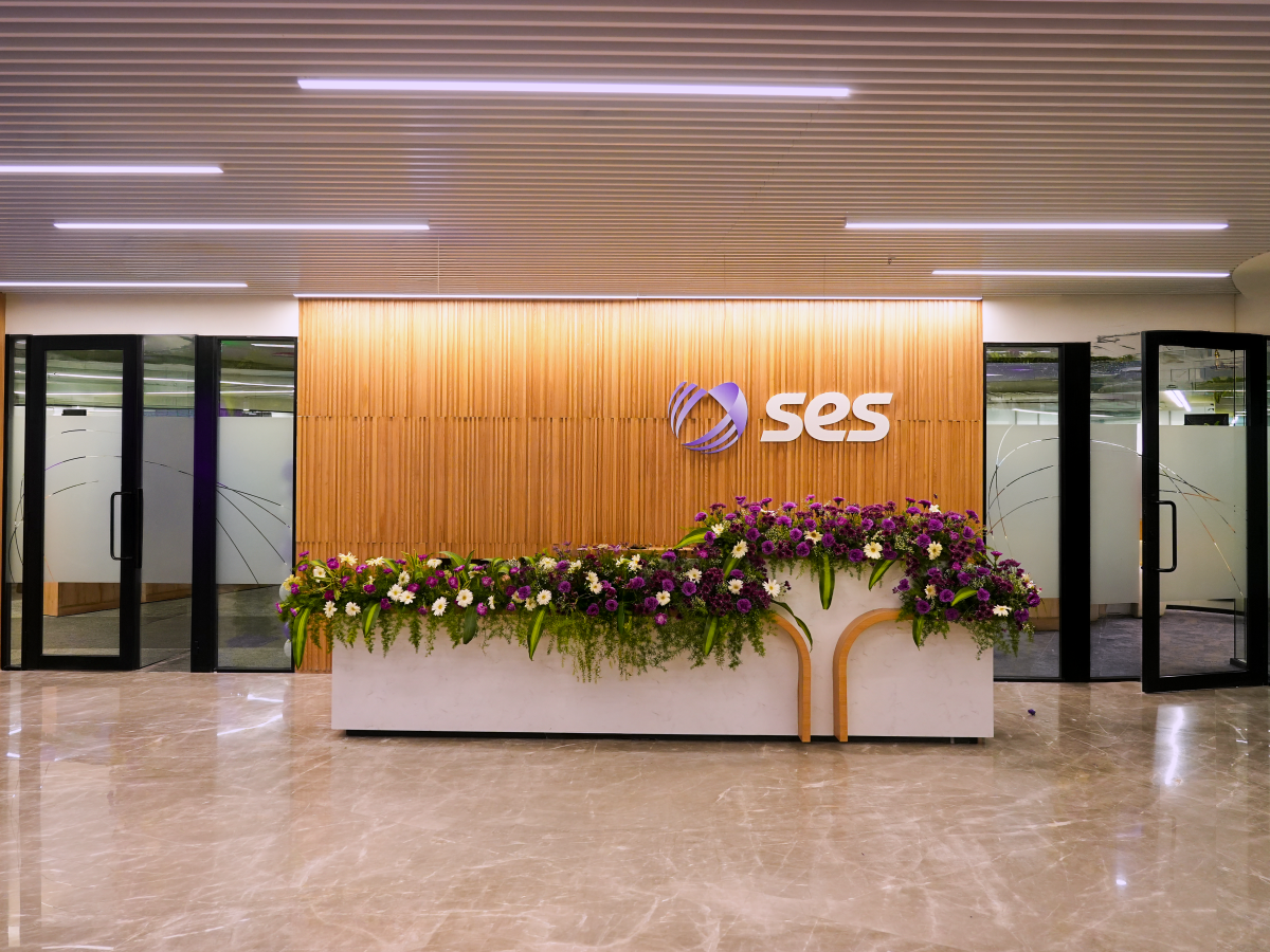 Image of front desk in Chennai office with SES logo behind 