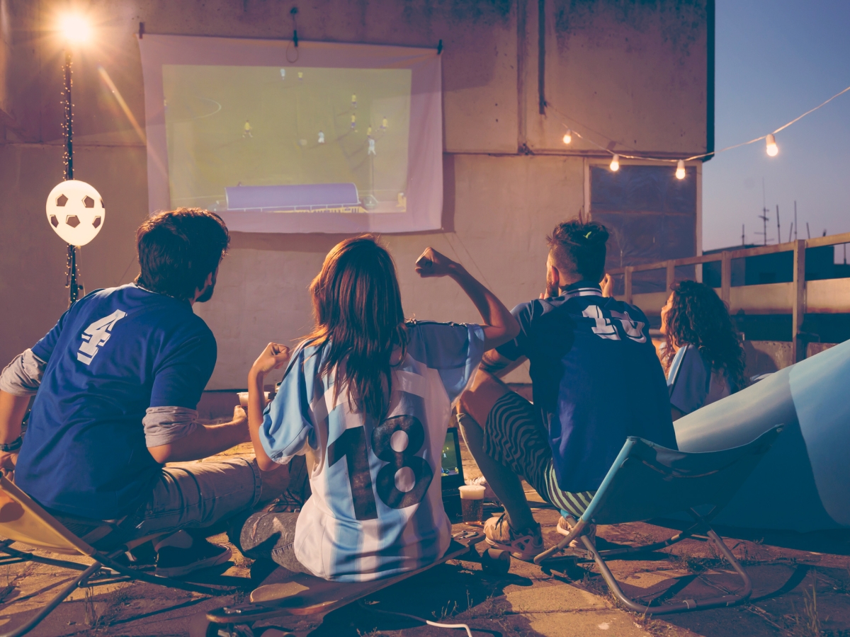 Group of people enjoying watching sports on a terrace